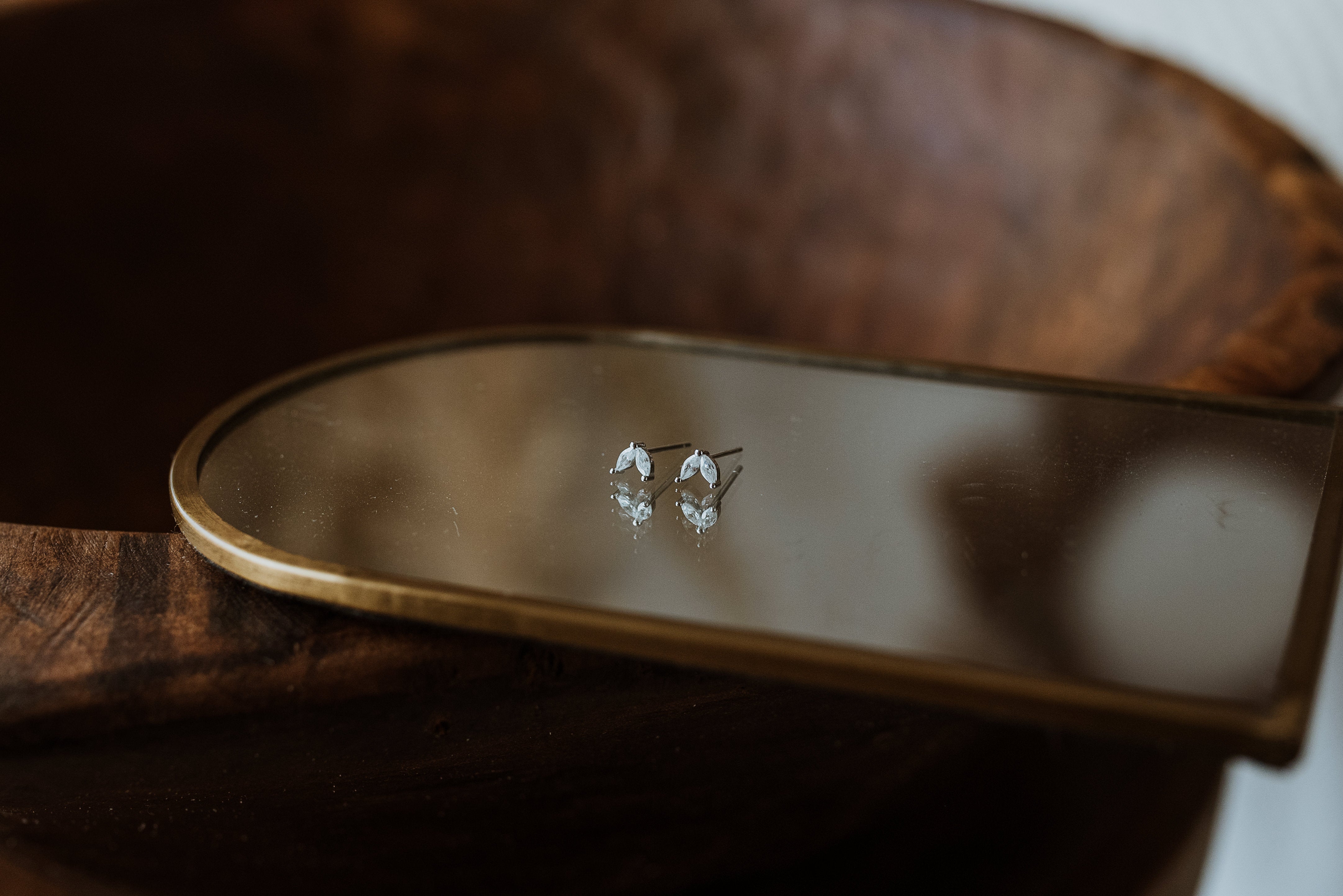 Small earrings on a wooden surface