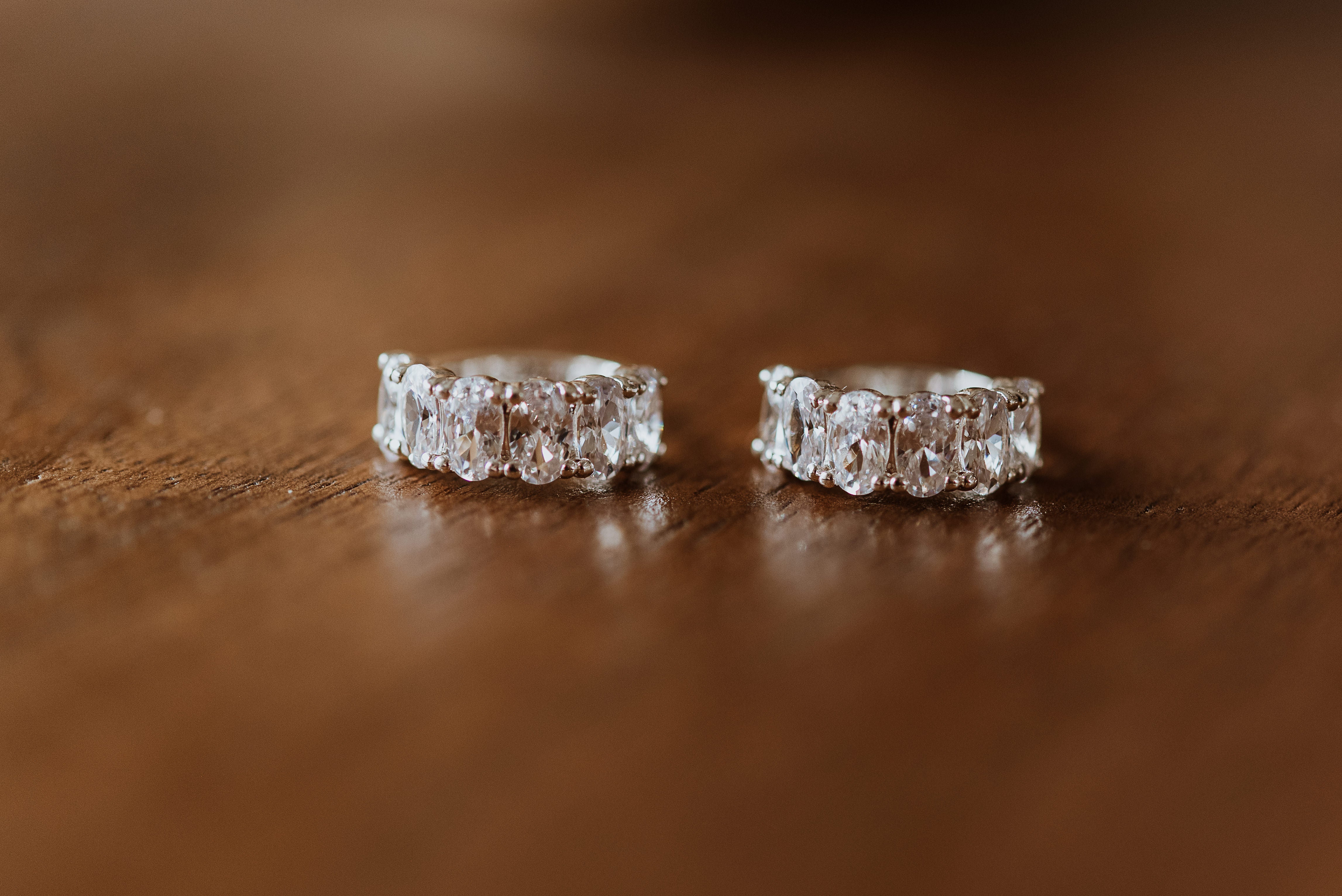 Pair of silver earrings on a wooden surface
