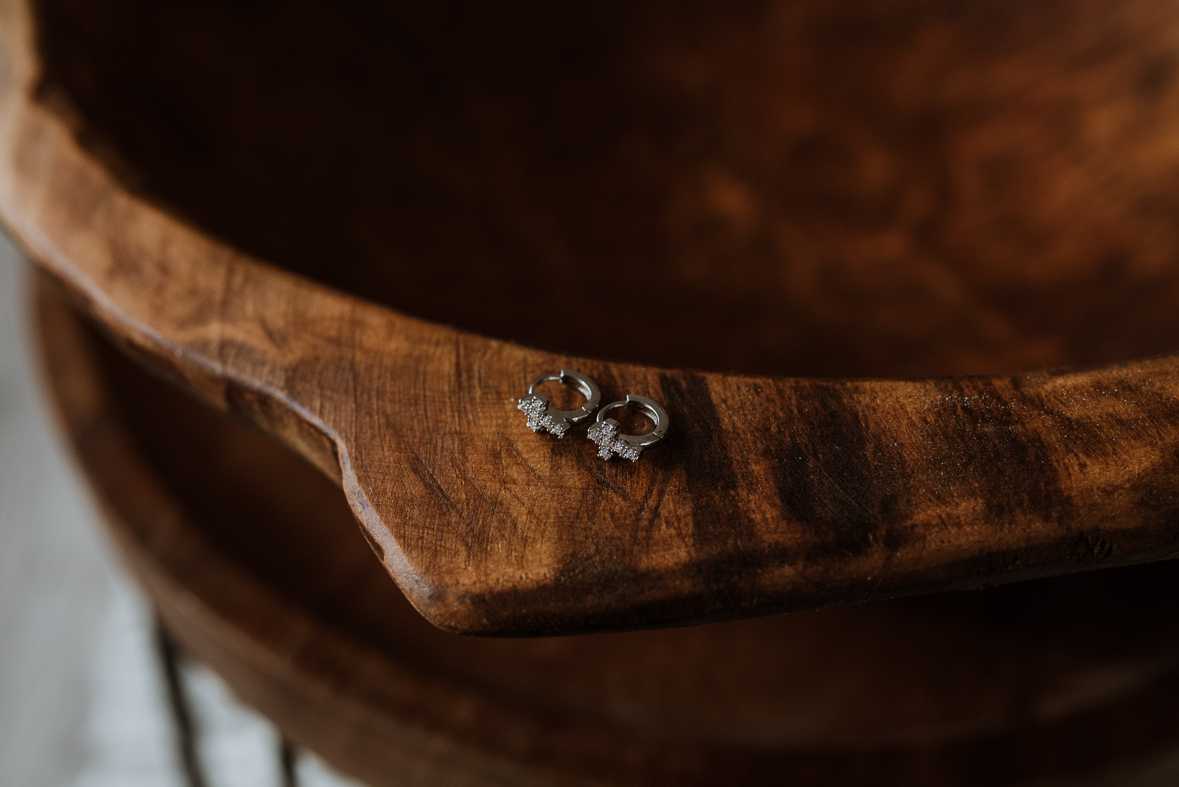 Pair of earrings on a wooden surface