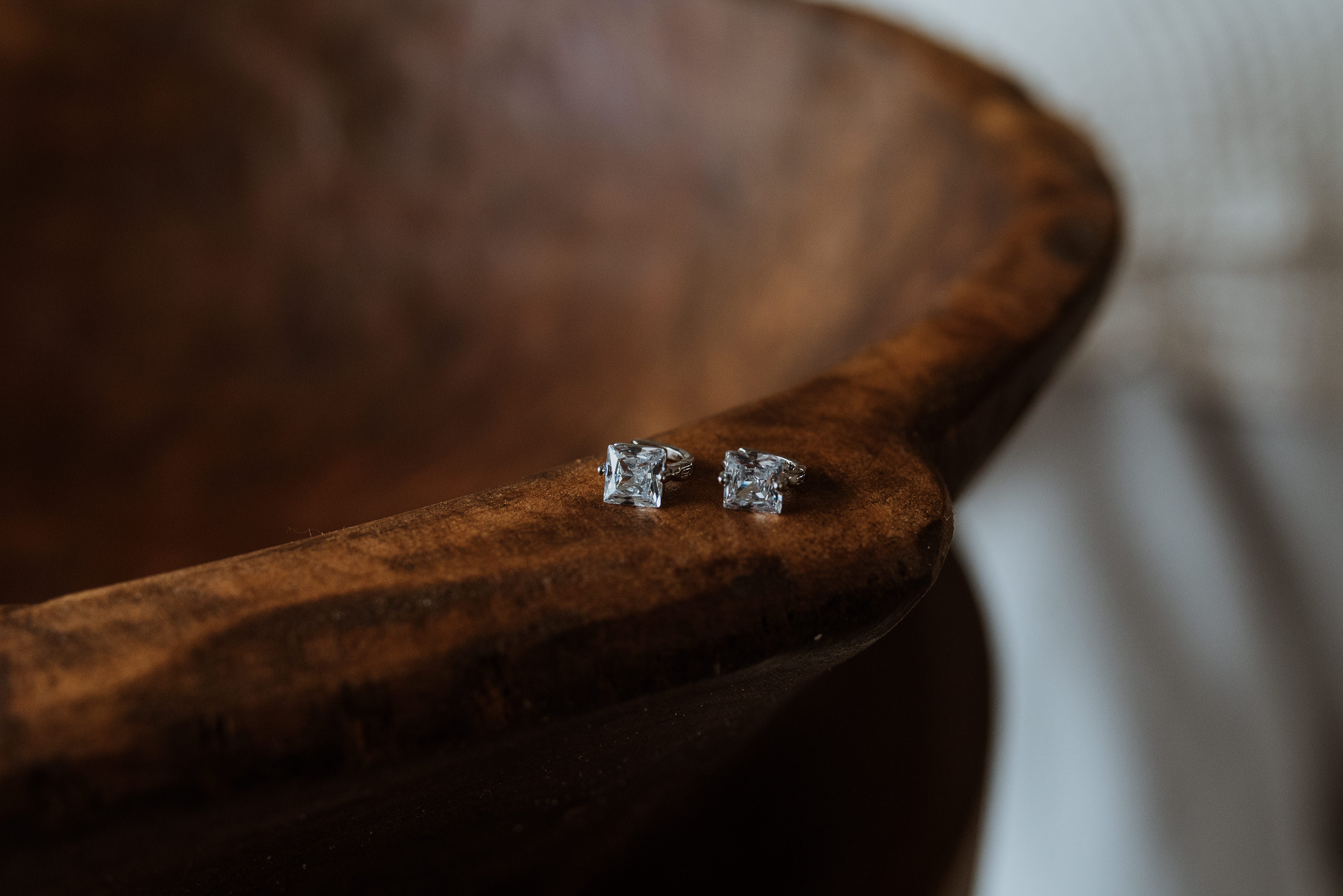 Pair of silver earrings on a wooden surface